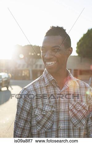 Stock Photo - Portrait of young man wearing checked shirt. Fotosearch