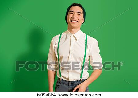 Picture - Portrait of young man wearing green braces. Fotosearch