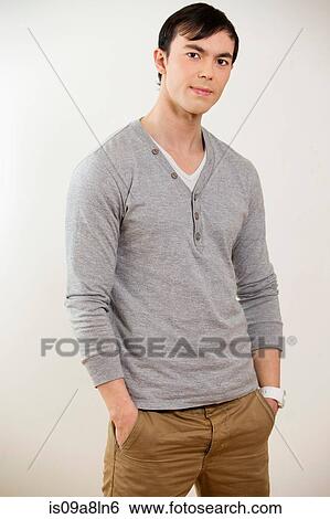 Portrait of young man wearing grey jumper View Large Photo Image Stock Photograph - Portrait of young man wearing grey jumper. Fotosearch
