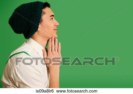 Stock Photograph - Portrait of young man wearing knit hat. Fotosearch