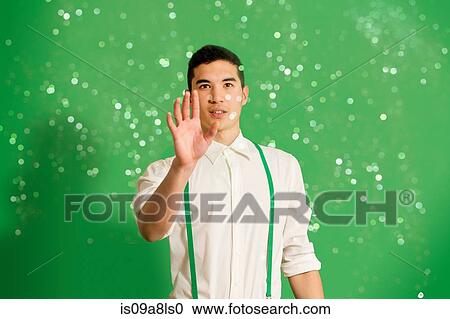 Stock Image - Portrait of young man with glitter. Fotosearch