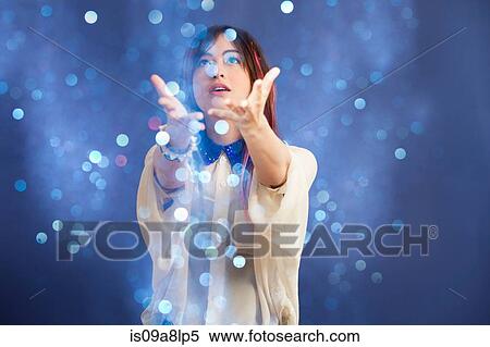 Portrait of young woman catching glitter View Large Photo Image Stock Photography - Portrait of young woman catching glitter. Fotosearch