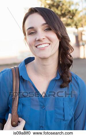 Portrait of young woman wearing blue blouse View Large Photo Image Stock Image - Portrait of young woman wearing blue blouse. Fotosearch