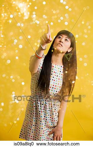 Portrait of young woman wearing spotted dress with glitter View Large Photo Image Stock Image - Portrait of young woman wearing spotted dress with glitter. Fotosearch