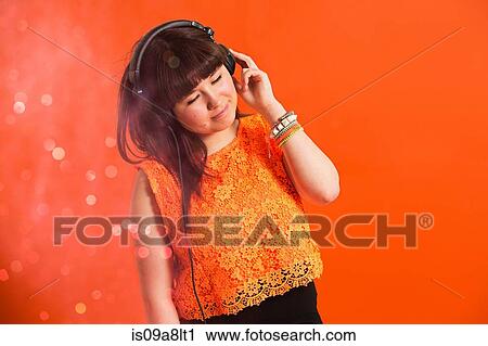 Portrait of young woman wearing headphones View Large Photo Image Stock Image - Portrait of young woman wearing headphones. Fotosearch