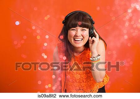 Portrait of young woman wearing headphones View Large Photo Image Stock Image - Portrait of young woman wearing headphones. Fotosearch