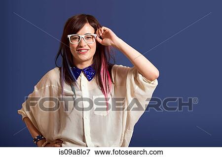 Portrait of young woman with dyed hair wearing glasses View Large Photo Image Stock Photo - Portrait of young woman with dyed hair wearing glasses. Fotosearch