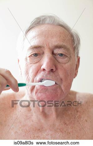 Stock Photograph - Senior man brushing teeth. Fotosearch