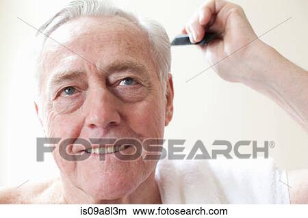 Picture - Senior man combing hair. Fotosearch