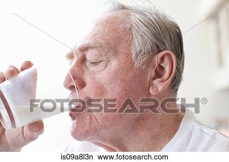 Senior man drinking glass of milk View Large Photo Image Picture - Senior man drinking glass of milk. Fotosearch