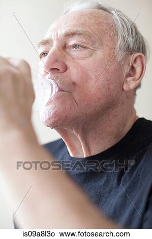 Senior man drinking mineral water View Large Photo Image Picture - Senior man drinking mineral water. Fotosearch