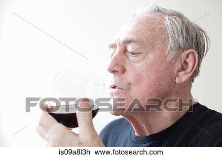 Stock Image - Senior man drinking red wine. Fotosearch