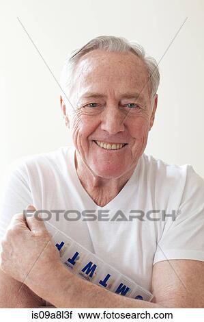 Senior man holding pill box View Large Photo Image Stock Image - Senior man holding pill box. Fotosearch