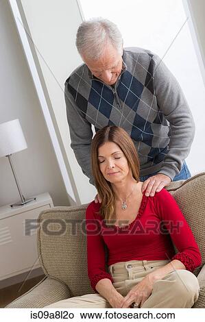 Picture - Senior man massaging woman's shoulders. Fotosearch