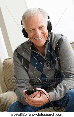 Senior man wearing headphones listening to music View Large Photo Image Stock Image - Senior man wearing headphones listening to music. Fotosearch