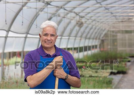 Senior man working in garden centre, portrait View Large Photo Image Stock Photography - Senior man working in garden centre, portrait. Fotosearch