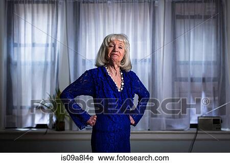 Senior woman in blue dress with hands on hips View Large Photo Image Stock Image - Senior woman in blue dress with hands on hips. Fotosearch