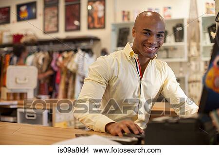 Shopkeeper using computer in vintage shop View Large Photo Image Picture - Shopkeeper using computer in vintage shop. Fotosearch