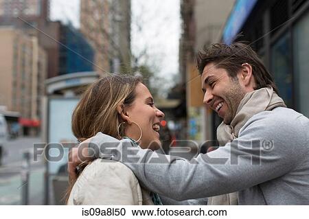 Smiling couple face to face on city street View Large Photo Image Stock Image - Smiling couple face to face on city street. Fotosearch