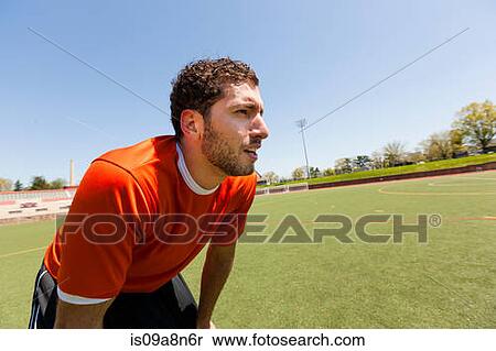 Soccer player taking a break on pitch View Large Photo Image Stock Photography - Soccer player taking a break on pitch. Fotosearch
