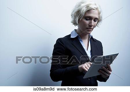 Studio portrait of blond businesswoman with digital tablet View Large Photo Image Stock Image - Studio portrait of blond businesswoman with digital tablet. Fotosearch