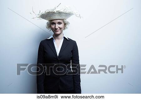 Studio portrait of blond businesswoman wearing straw hat View Large Photo Image Stock Image - Studio portrait of blond businesswoman wearing straw hat. Fotosearch