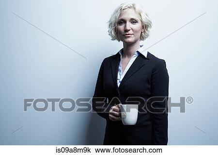 Studio portrait of blond businesswoman holding mug of tea View Large Photo Image Stock Image - Studio portrait of blond businesswoman holding mug of tea. Fotosearch