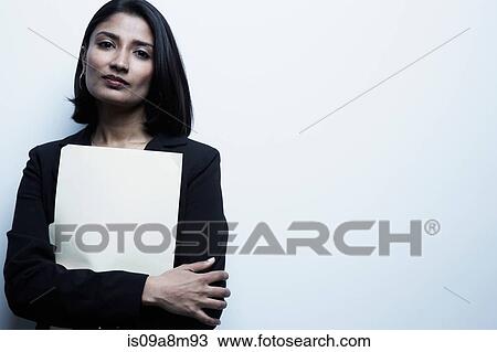 Studio portrait of businesswoman holding paperwork View Large Photo Image Stock Image - Studio portrait of businesswoman holding paperwork. Fotosearch