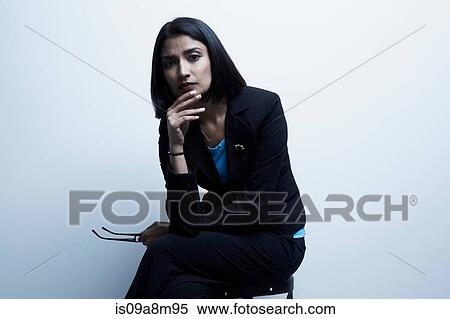 Studio portrait of businesswoman holding spectacles View Large Photo Image Stock Photography - Studio portrait of businesswoman holding spectacles. Fotosearch