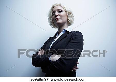 Studio portrait of businesswoman with arms crossed View Large Photo Image Stock Photo - Studio portrait of businesswoman with arms crossed. Fotosearch