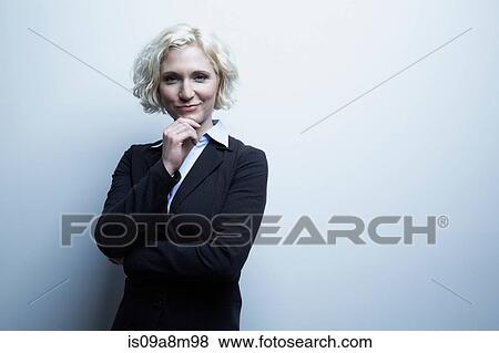 Studio portrait of businesswoman with hand on chin View Large Photo Image Stock Photo - Studio portrait of businesswoman with hand on chin. Fotosearch