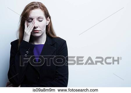 Studio portrait of young businesswoman rubbing eyes View Large Photo Image Picture - Studio portrait of young businesswoman rubbing eyes. Fotosearch