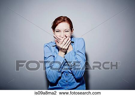Studio portrait of young woman giggling View Large Photo Image Stock Image - Studio portrait of young woman giggling. Fotosearch
