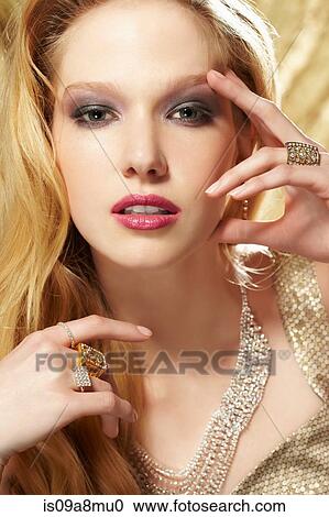 Studio portrait of young woman wearing diamond rings View Large Photo Image Stock Image - Studio portrait of young woman wearing diamond rings. Fotosearch