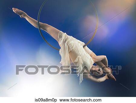 Studio shot of aerialist performing on hoop View Large Photo Image Stock Photography - Studio shot of aerialist performing on hoop. Fotosearch