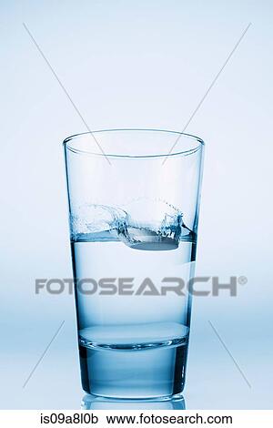 Tablet falling in glass of water View Large Photo Image Stock Image - Tablet falling in glass of water. Fotosearch