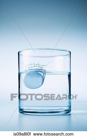 Tablet falling in glass of water View Large Photo Image Stock Image - Tablet falling in glass of water. Fotosearch