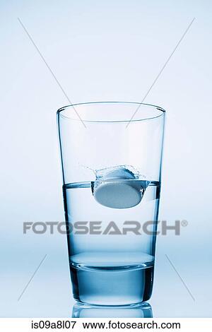 Tablet falling in glass of water View Large Photo Image Stock Photo - Tablet falling in glass of water. Fotosearch