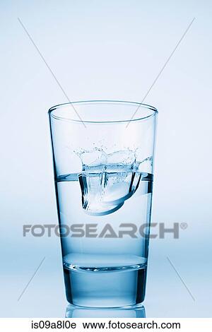 Tablets falling in glass of water View Large Photo Image Stock Image - Tablets falling in glass of water. Fotosearch