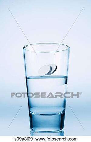 Stock Photo - Tablets falling in glass of water. Fotosearch