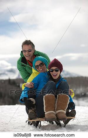 Three friends sitting on sledge in snow View Large Photo Image Stock Photo - Three friends sitting on sledge in snow. Fotosearch