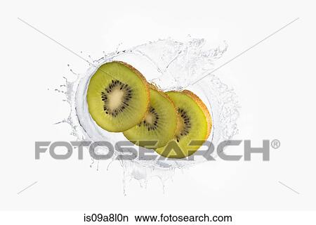 Three slices of kiwi splashing in liquid View Large Photo Image Picture - Three slices of kiwi splashing in liquid. Fotosearch