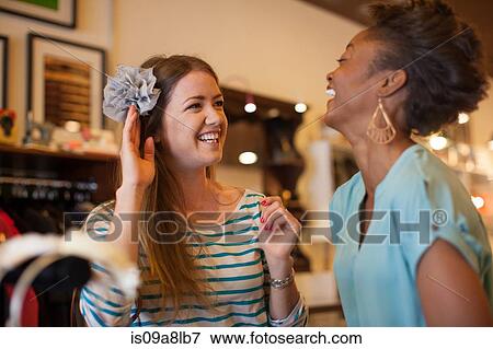 Two friends buying hair accessory in vintage shop View Large Photo Image Stock Photo - Two friends buying hair accessory in vintage shop. Fotosearch