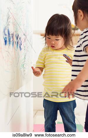 Two young sister making handprints View Large Photo Image Stock Photo - Two young sister making handprints. Fotosearch