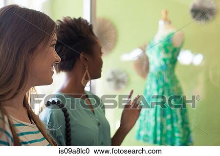 Stock Image - Two young women in vintage shop. Fotosearch