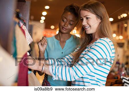 Two young women in vintage shop View Large Photo Image Stock Photo - Two young women in vintage shop. Fotosearch