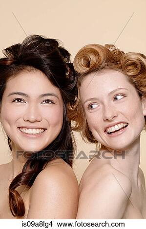 Two young women, one brunette and one redhead View Large Photo Image Picture - Two young women, one brunette and one redhead. Fotosearch