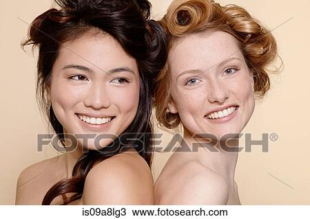 Two young women, one brunette and one redhead View Large Photo Image Stock Image - Two young women, one brunette and one redhead. Fotosearch