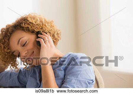 Stock Image - Woman on mobile phone, portrait. Fotosearch