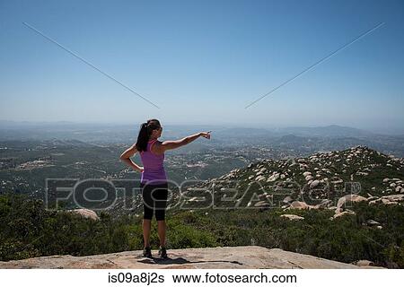 Stock Photograph - Woman pointing to view of San Diego, California, USA. Fotosearch